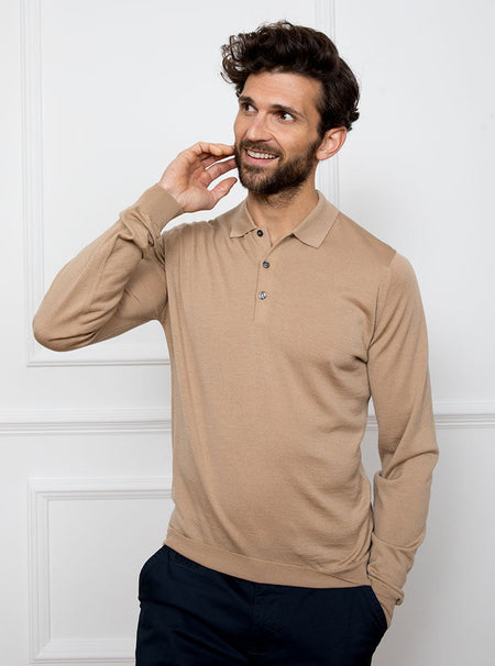 Man wearing light camel long sleeved polo neck sweater knit in 100% luxury and premium merino wool.